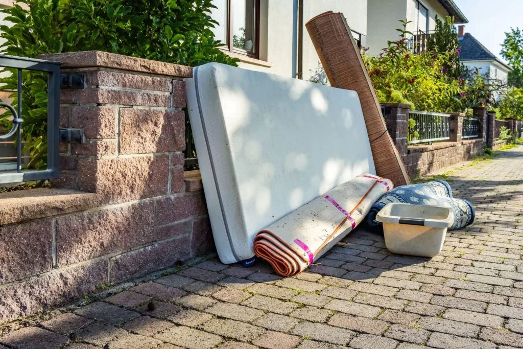 Current image: junk removal team loading bulky household items for disposal in Edmonton